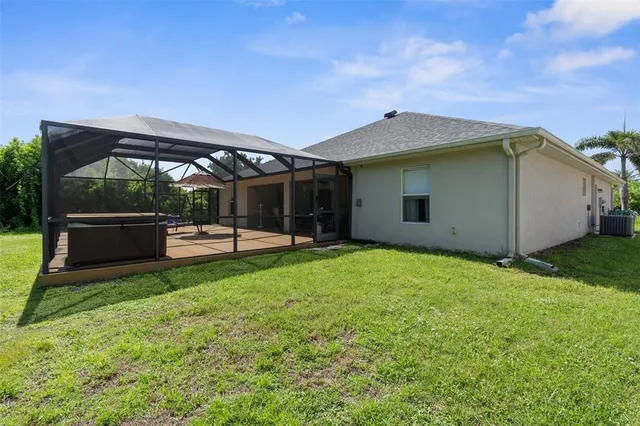 a backyard of a house with table and chairs