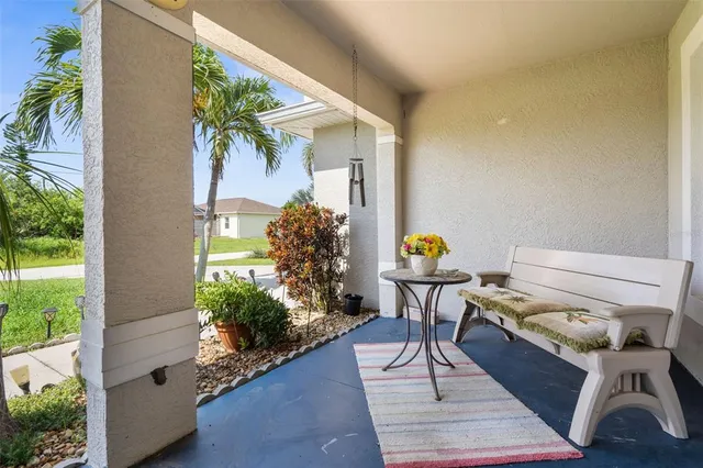a backyard of a house with wooden floor and outdoor seating