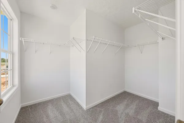 a view of an empty walk in closet with a bathroom