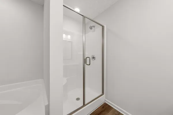 a bathroom with a glass shower door