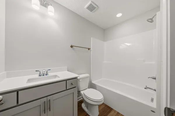a bathroom with a sink toilet vanity and bathtub