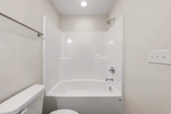 a bathroom with a bathtub and a toilet