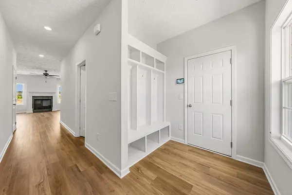 a view of a hallway with wooden floor and staircase