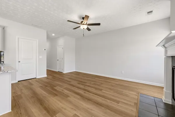 a view of empty room with ceiling fan