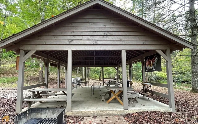 a view of patio with a table and chairs under an umbrella