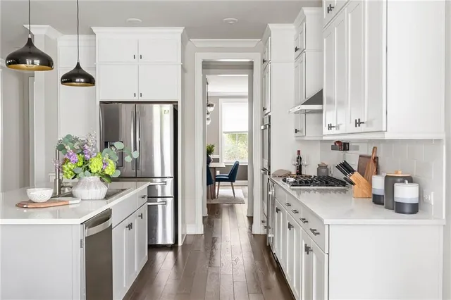a view of a kitchen with dining table and chairs
