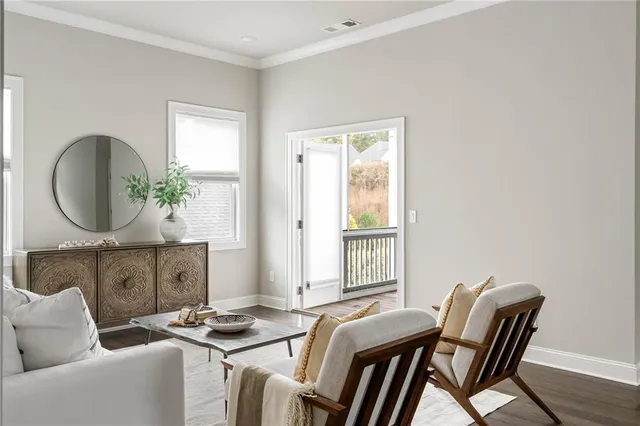a view of a balcony with chairs and wooden floor