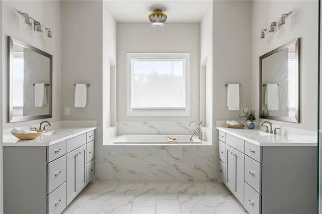 a en suite bathroom with double sink shower and a mirror