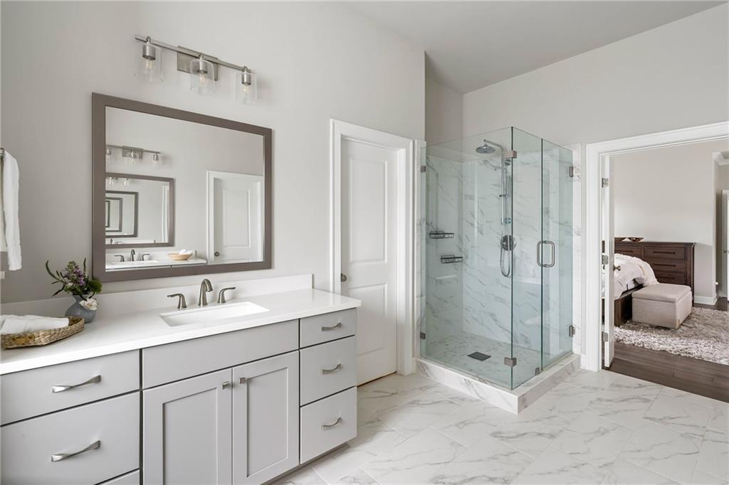 550 Central Park Overlook Alpharetta, GA 30004 - Photo 28 of 51 a en suite bathroom with double sink shower and a mirror