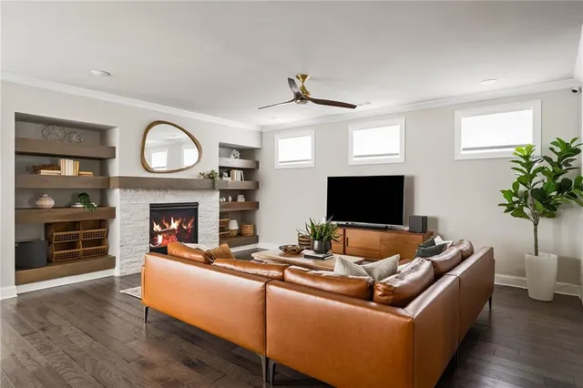 a living room with furniture a fireplace and a flat screen tv