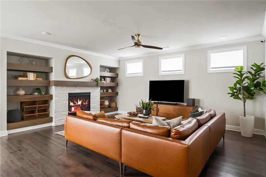 550 Central Park Overlook Alpharetta, GA 30004 - Photo 4 of 51 a living room with furniture a fireplace and a flat screen tv