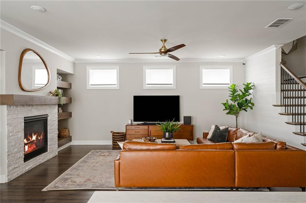 550 Central Park Overlook Alpharetta, GA 30004 - Photo 5 of 51 a living room with furniture a fireplace and a flat screen tv