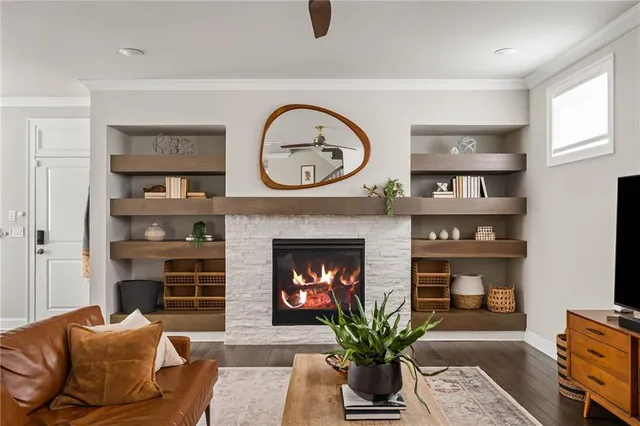 a living room with stainless steel appliances kitchen island granite countertop furniture and a large window