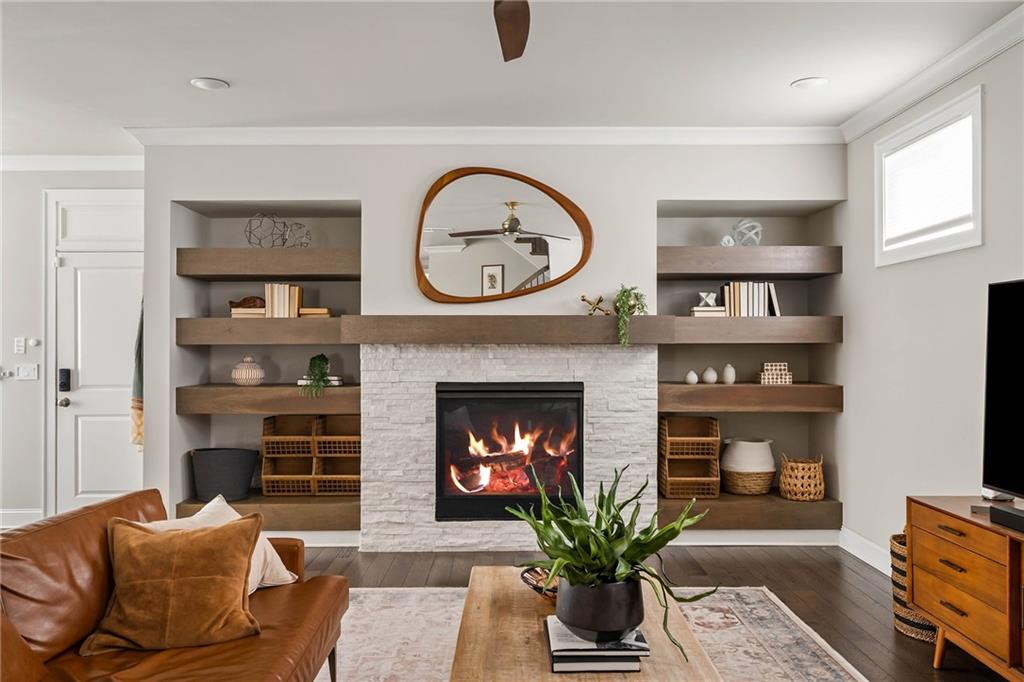 550 Central Park Overlook Alpharetta, GA 30004 - Photo 6 of 51 a living room with furniture a clock and a fireplace