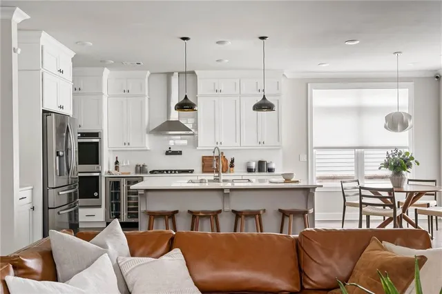 a kitchen with appliances a sink and cabinets