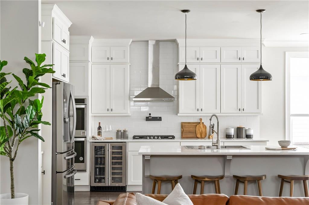 550 Central Park Overlook Alpharetta, GA 30004 - Photo 9 of 51 a kitchen with appliances a sink and cabinets