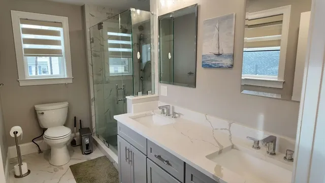 a bathroom with a sink toilet and shower