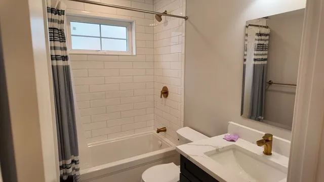 a bathroom with a sink toilet and shower