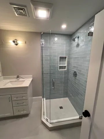 a bathroom with a shower and a sink