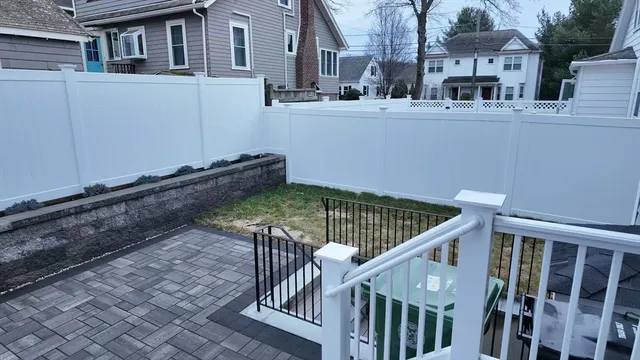 a view of a house with backyard and deck