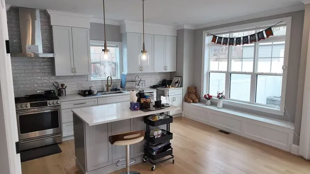 a kitchen with a sink stove and cabinets
