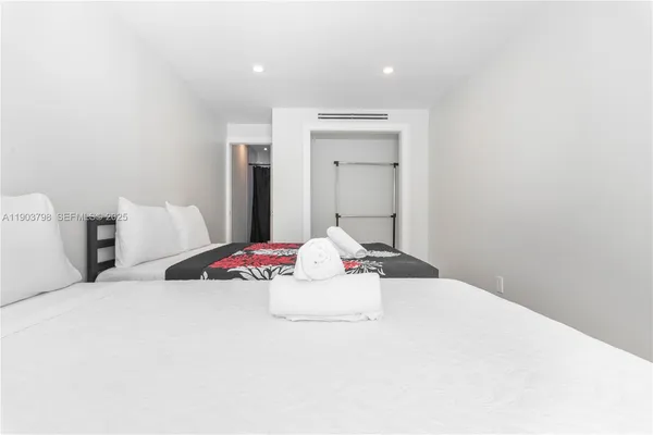 a view of a hallway with a bedroom and a window