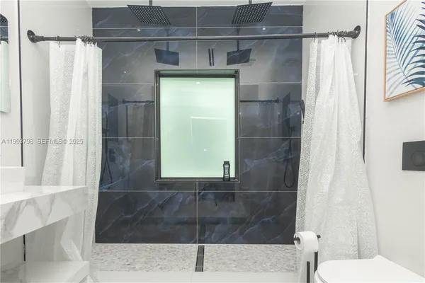 a view of a hallway with wooden floor and a door