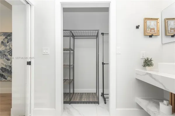 a bedroom with a bed and painting on the wall