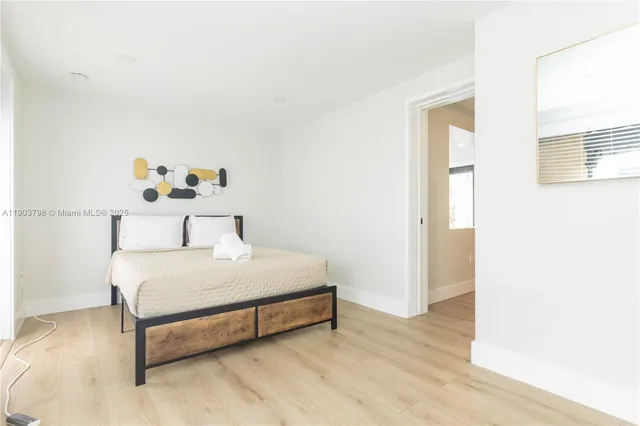 a open kitchen with stainless steel appliances kitchen island granite countertop a table and chairs in it