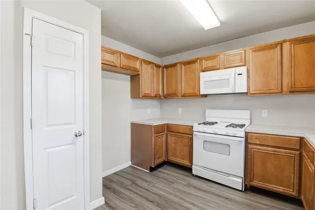 a kitchen with stainless steel appliances granite countertop a stove a sink and a microwave