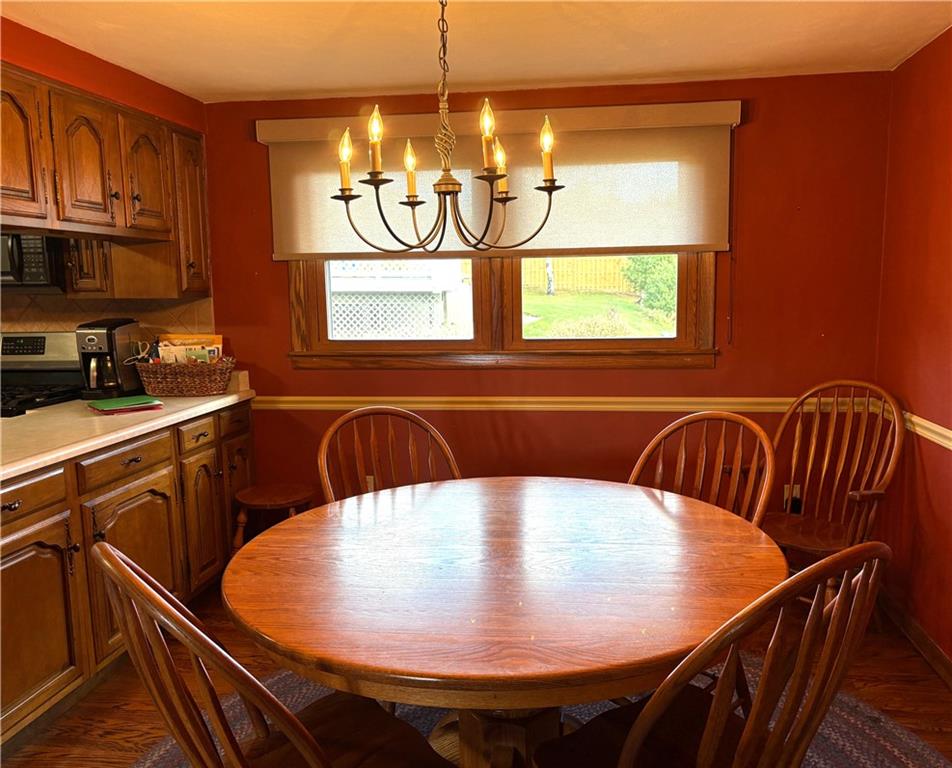 5719 Halchess Street Pittsburgh, PA 15207 - Photo 11 of 25 a view of a dining room with furniture and chandelier