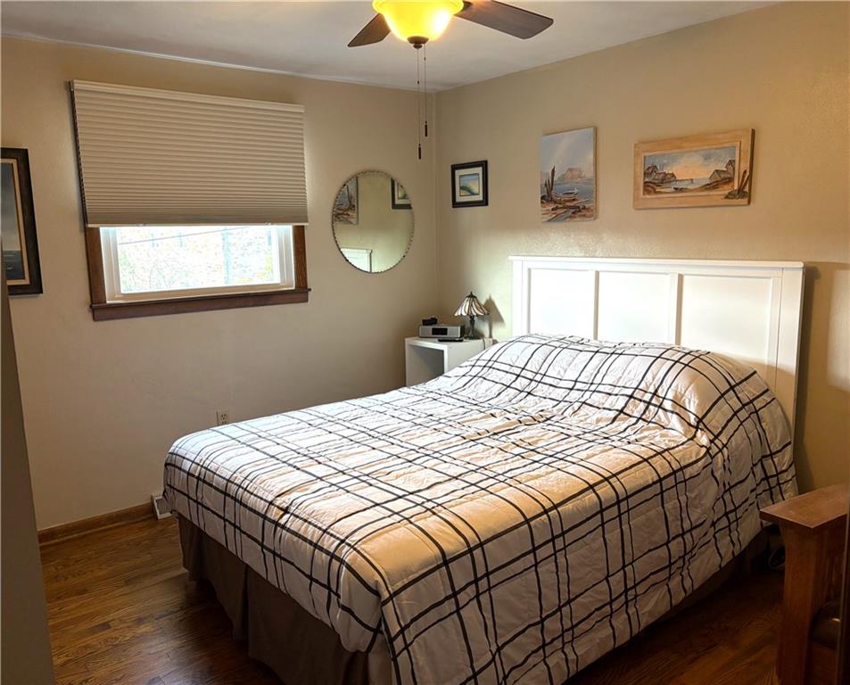 5719 Halchess Street Pittsburgh, PA 15207 - Photo 15 of 25 a bedroom with a bed and a chandelier