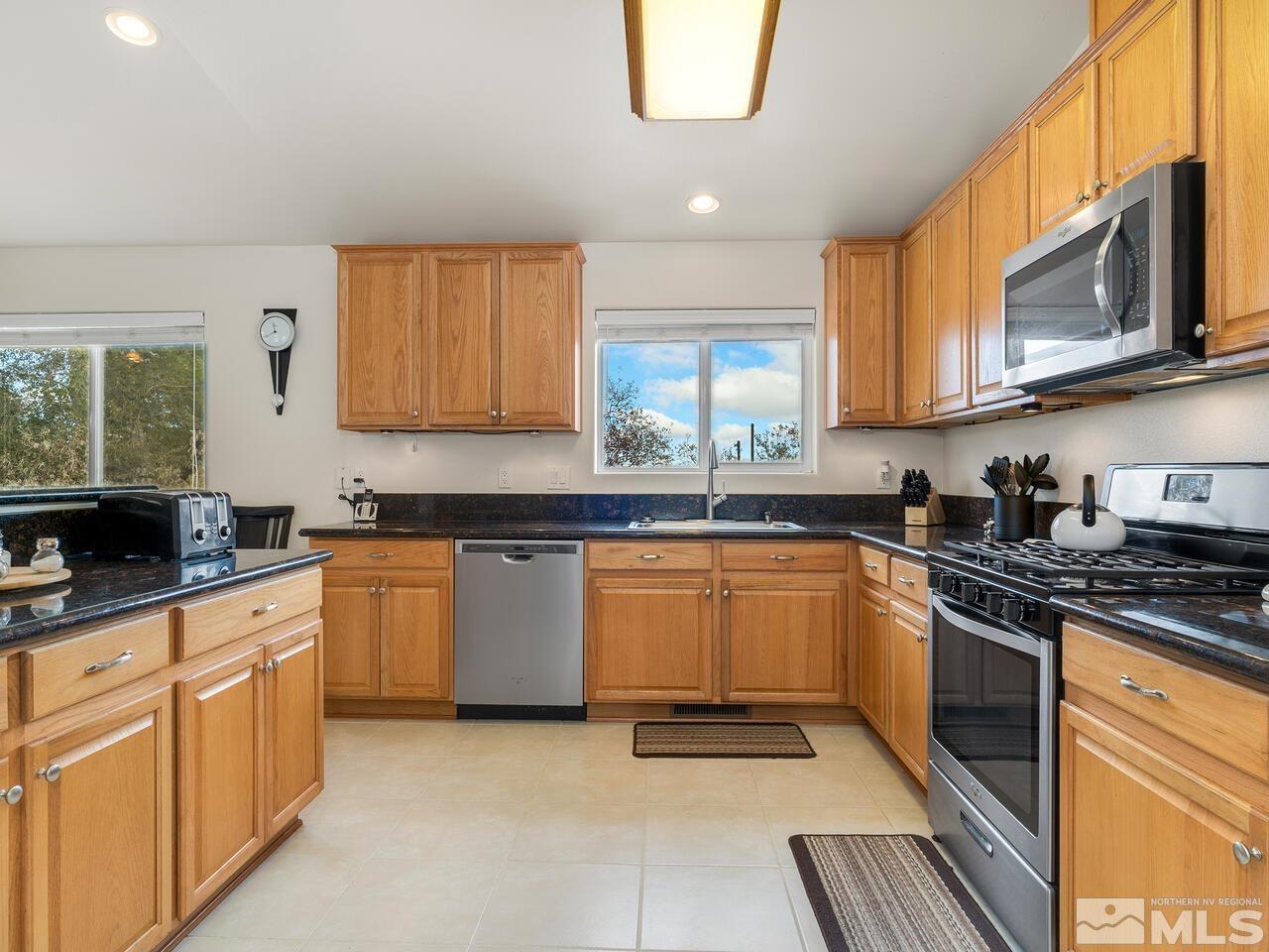 160 Hoge Road Reno, NV 89506 - Photo 6 of 19 a kitchen with granite countertop a sink stainless steel appliances and cabinets