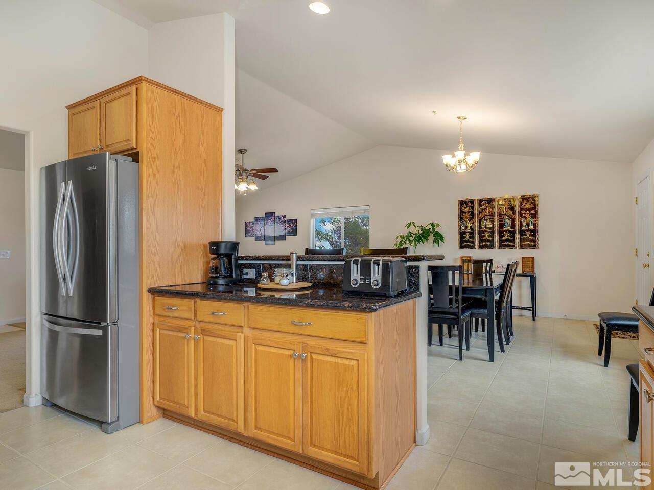 160 Hoge Road Reno, NV 89506 - Photo 7 of 19 a kitchen with stainless steel appliances granite countertop a refrigerator and a stove top oven
