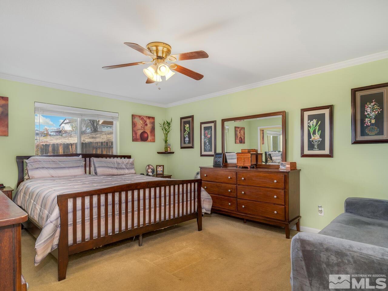 160 Hoge Road Reno, NV 89506 - Photo 8 of 19 a bed room with a bed and a chandelier
