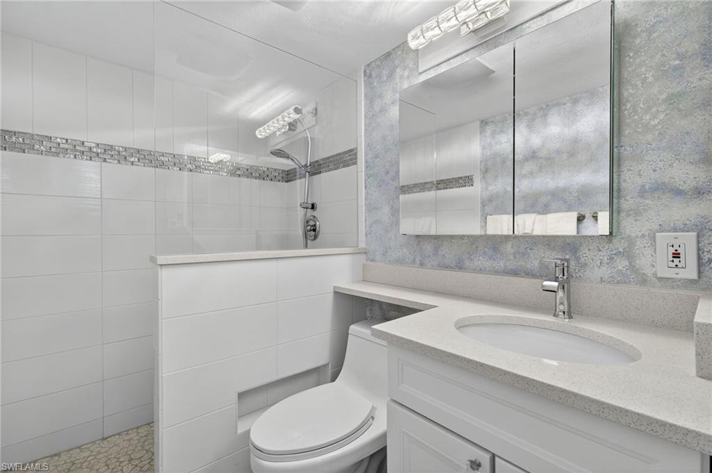 5900 Bonita Beach Road Southwest, Unit 1602 Bonita Springs, FL 34134 - Photo 14 of 26 Full bath featuring walk in shower, vanity, and wallpapered walls