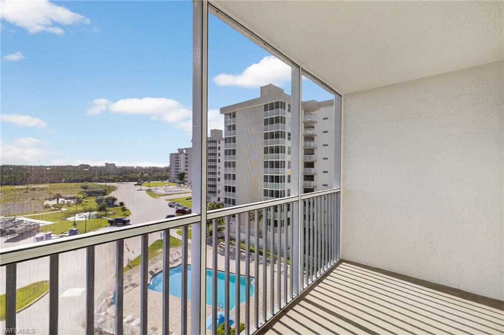 5900 Bonita Beach Road Southwest, Unit 1602 Bonita Springs, FL 34134 - Photo 15 of 26 Balcony with view of pool area and a sunroom