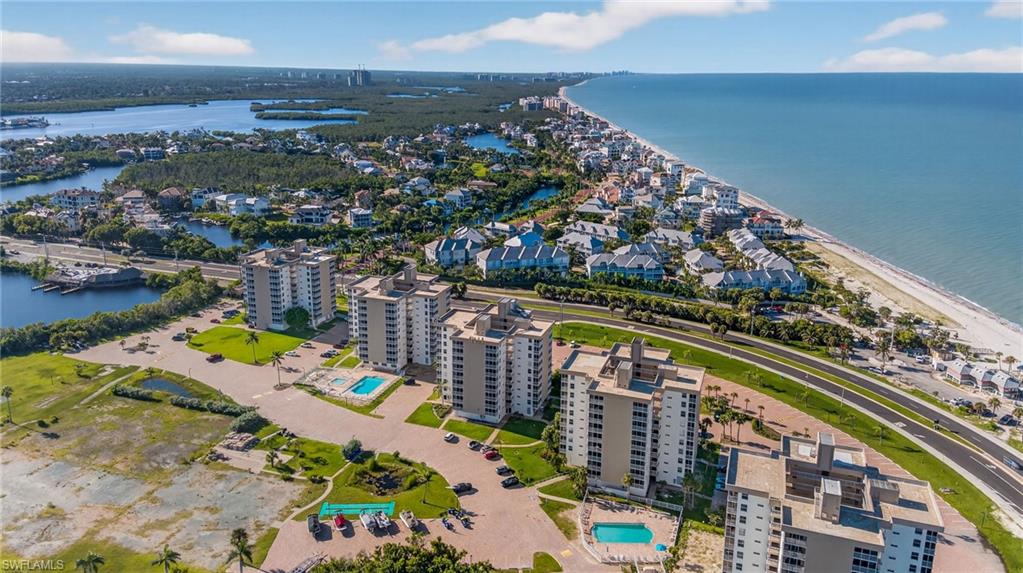 5900 Bonita Beach Road Southwest, Unit 1602 Bonita Springs, FL 34134 - Photo 22 of 26 Aerial view of property's location with a nearby body of water and nearby suburban area