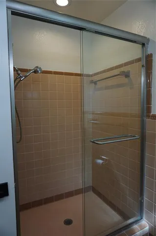 a bathroom with a glass shower door