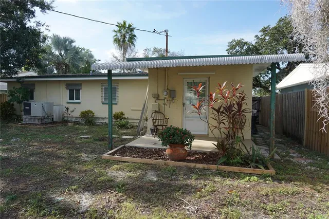 a backyard of a house with table and chairs
