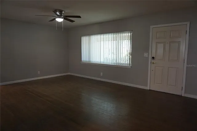 a view of wooden floor and windows in a room