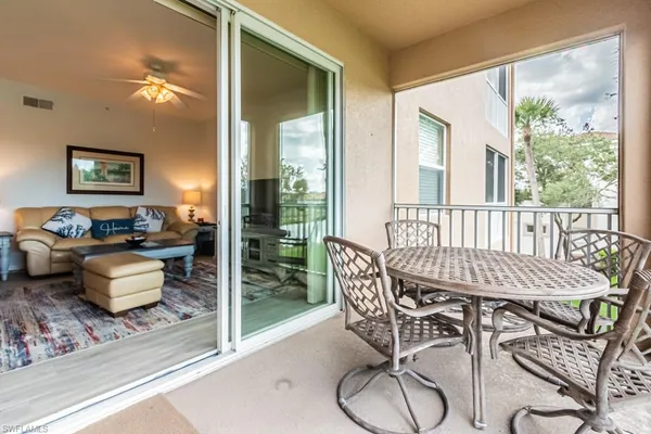 a kitchen with granite countertop cabinets and chairs