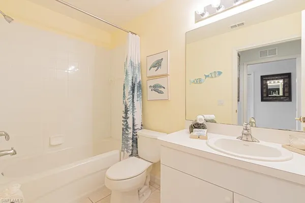 a bedroom with two beds and a chandelier