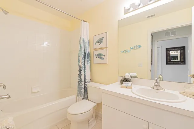 a bedroom with two beds and a chandelier