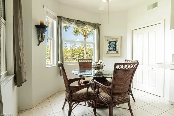 a view of a dining room with furniture and a window