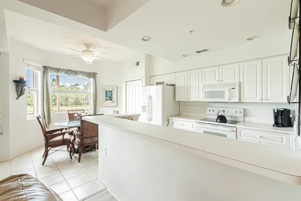 a view of kitchen with furniture and refrigerator