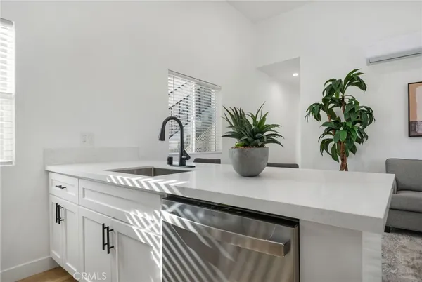 a living room with furniture stove and potted plant