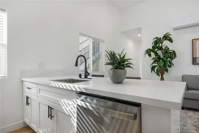 a living room with furniture stove and potted plant