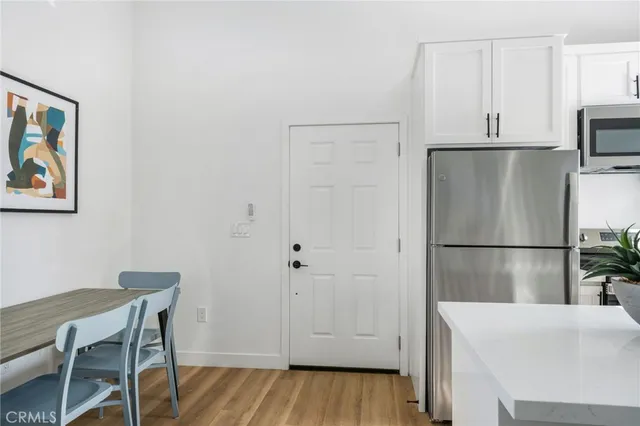 a view of a street with potted plants
