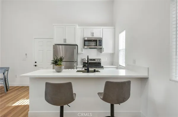 a kitchen with a refrigerator and a table